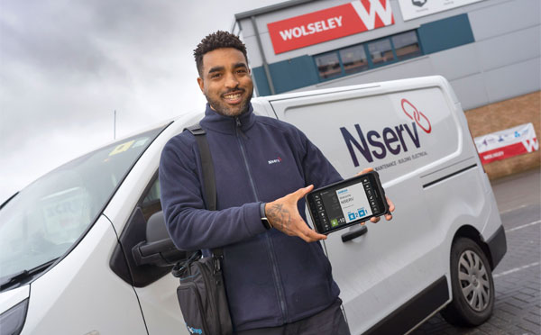 Nserv employee holding a BigChange mobile device