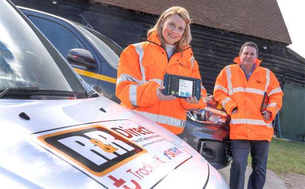 R&R Employee holding a BigChange mobile device